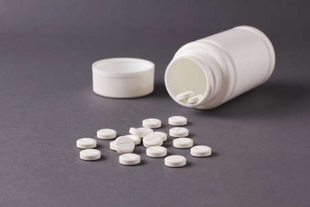 a lot of pills on a gray backgroundの写真素材