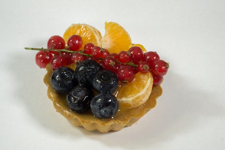 Cupcake with fresh bio fruit, orange, blueberry, red currant, side view photo, white background, isolateの写真素材