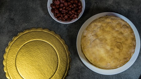 Ingredients for homemade cherry pie, on a stone table, biscuits, cherries, cake standの写真素材