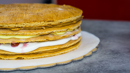 Cream biscuit, a protruding cream between biscuit cakes, on a stone tableの写真素材