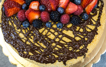 Hat cake, chocolate, strawberry, raspberry, blackberry and berries top viewtasty homemade cakesの写真素材
