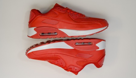 on a white background, close-up, sports sneakers red, with a white sole, there is a shadow,beauty and fashionの写真素材