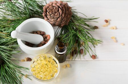 Top view, natural cosmetics, natural eco product, composition glass bottles with cedar oil, pine nuts, mortar, cedar essential oil. Copy spaceの写真素材