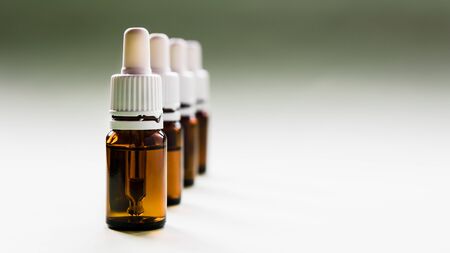 cosmetology, a row of glass bottles with pipettes and hyaluronic acid inside on a light backgroundの写真素材
