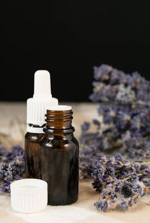 aromatherapy, lavender flowers with a bottle of essential oil on the table close-upの写真素材