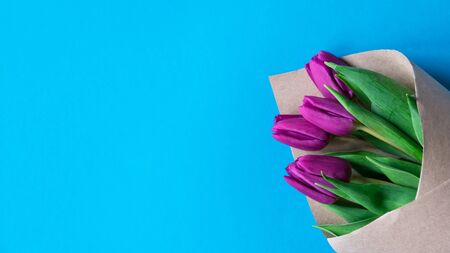 Bouquet of pink tulips on blue pastel background, copy space. Spring minimal concept. Womens Day, Mothers Day, Valentine's Day, Easter, birthday. Nature background. Flat lay, top viewの写真素材