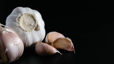 natural food, heads of garlic on a black background
