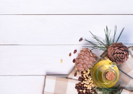 Cedar oil Bottles with pine oil and pine nuts, isolated on a white backgroundの写真素材
