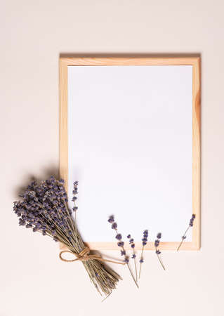 mock up for text, top view, white sheet of paper in a frame with lavender flowersの写真素材