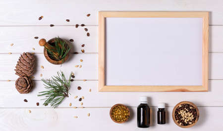 Healthy nutrition concept, cedar, nut cone and oil. Layout for writing text. View from aboveの写真素材