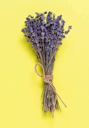 bouquet of lavender flowers on yellow background, top viewの写真素材