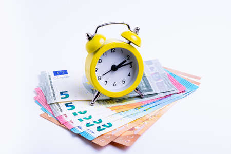 business concept, clock with money bills on white background, isolate