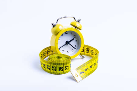 weight loss concept, watch isolate with measuring tape on white background, isolateの写真素材