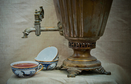 Still Life with old retro samovar and cup of teaの写真素材