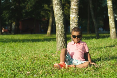Afro American boy on playground in park.の写真素材