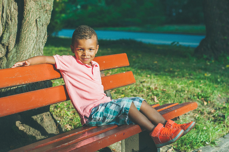 Afro American boy on playground in park.の写真素材