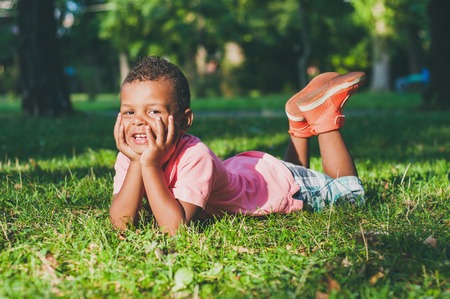 Afro American boy on playground in park.の写真素材