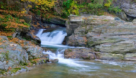 Beautiful waterfall in autumn forest, motion blur