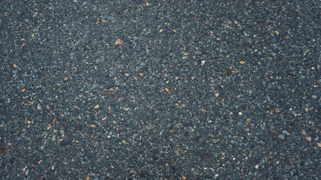 Fine-grained asphalt, in the afternoon after rain.