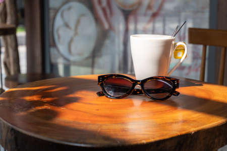 A mug and glasses on the tableの写真素材