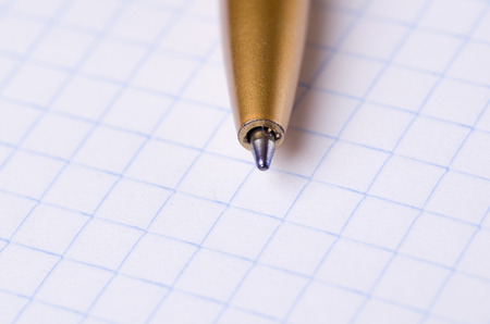 pen close-up on a notebook isolated on white background.