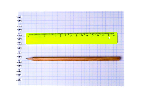 ruler and pencil on notebook isolated on white background.の写真素材