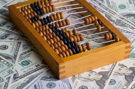 old abacus on a pile of dollars.の写真素材