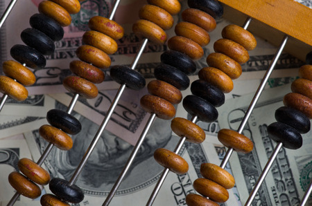 old abacus close-up on a bunch of US dollars.の写真素材