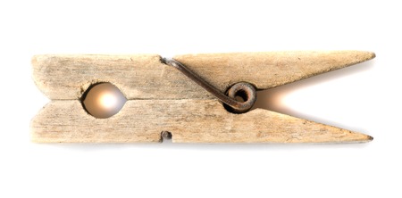 old wooden clothespin isolated on a white background .