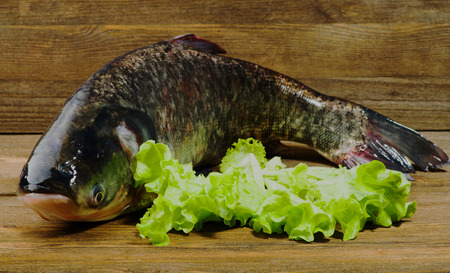 raw fish on wooden table as background .の写真素材