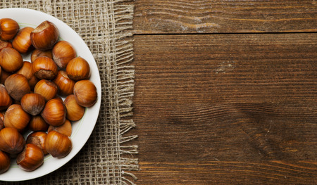 pile of nuts in shell on wooden table .の写真素材