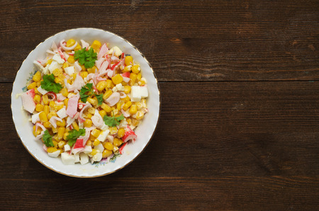 crab salad in a plate on a wooden table.Rustic style. Top view. Free space for text.の写真素材