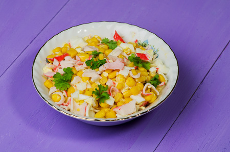 crab salad in a plate on a wooden table.Rustic style.の写真素材