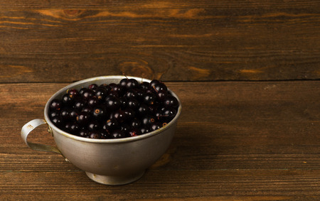 black currant on a wooden background.Rustic style. Free space for text.の写真素材