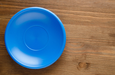 plate on a wooden background.blue  plate top view. copy space .の写真素材