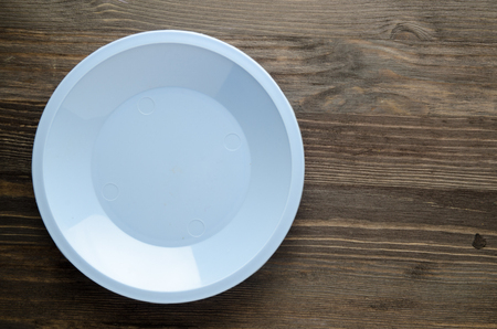 plate on a wooden background. plate top view. copy space .の写真素材