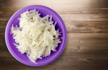 daikon on a wooden background. daikon on a plateの写真素材