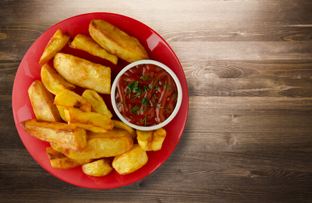 french fries with ketchup on a wooden background. french fries on a plateの写真素材