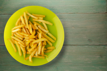  fry potatoes on a wooden background. fry potatoes on a plateの写真素材