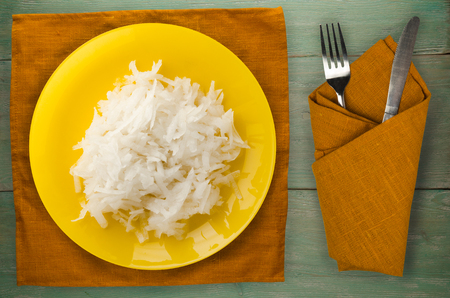 daikon on a wooden background. daikon on a plateの写真素材