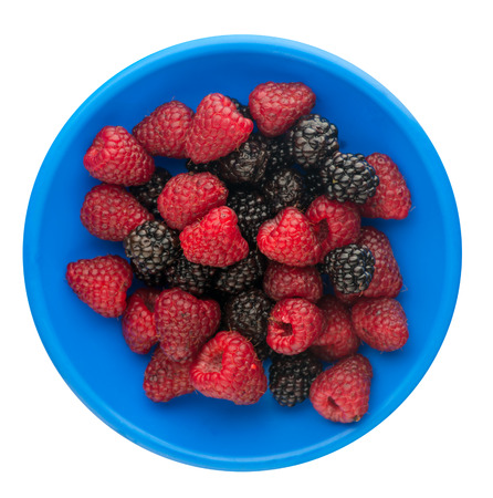blackberry and raspberry isolated on white background. blackberries and raspberries on a plate.