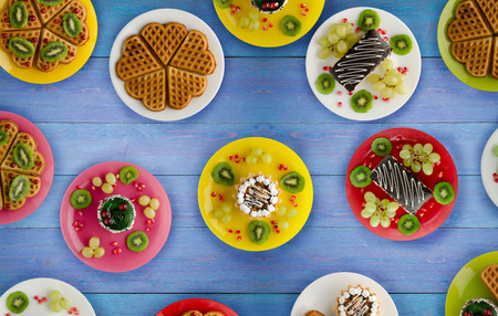 cakes, cookies waffles on the table. dessert for a festive table. sweets view from aboveの写真素材