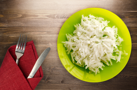 daikon on a wooden background. daikon on a plateの写真素材