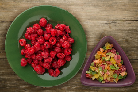 raspberries on a plate. raspberries on wooden background. raspberry top view .