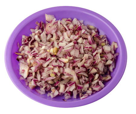 red onion isolated on white background. chopped red onion on a plateの写真素材