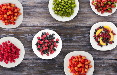 fruits on a plate. vegetarian food on wooden background. vegan food top view .の写真素材