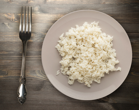 white rice on a plate. rice on a wooden background top view .Asian healthy foodの写真素材