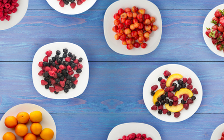 fruits on a plate. vegetarian food on wooden background. vegan food top view .の写真素材