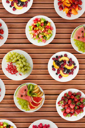 Fruit diet. Fruits on a plate on a wooden background. Healthy food .の写真素材