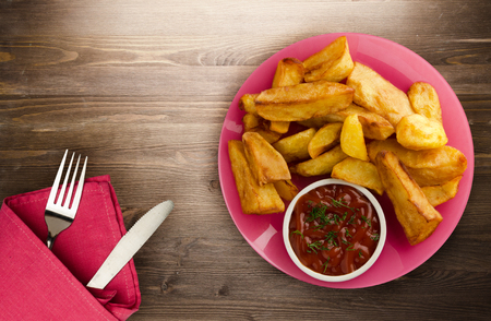 fry potatoes on a wooden background. fry potatoes on a plateの写真素材